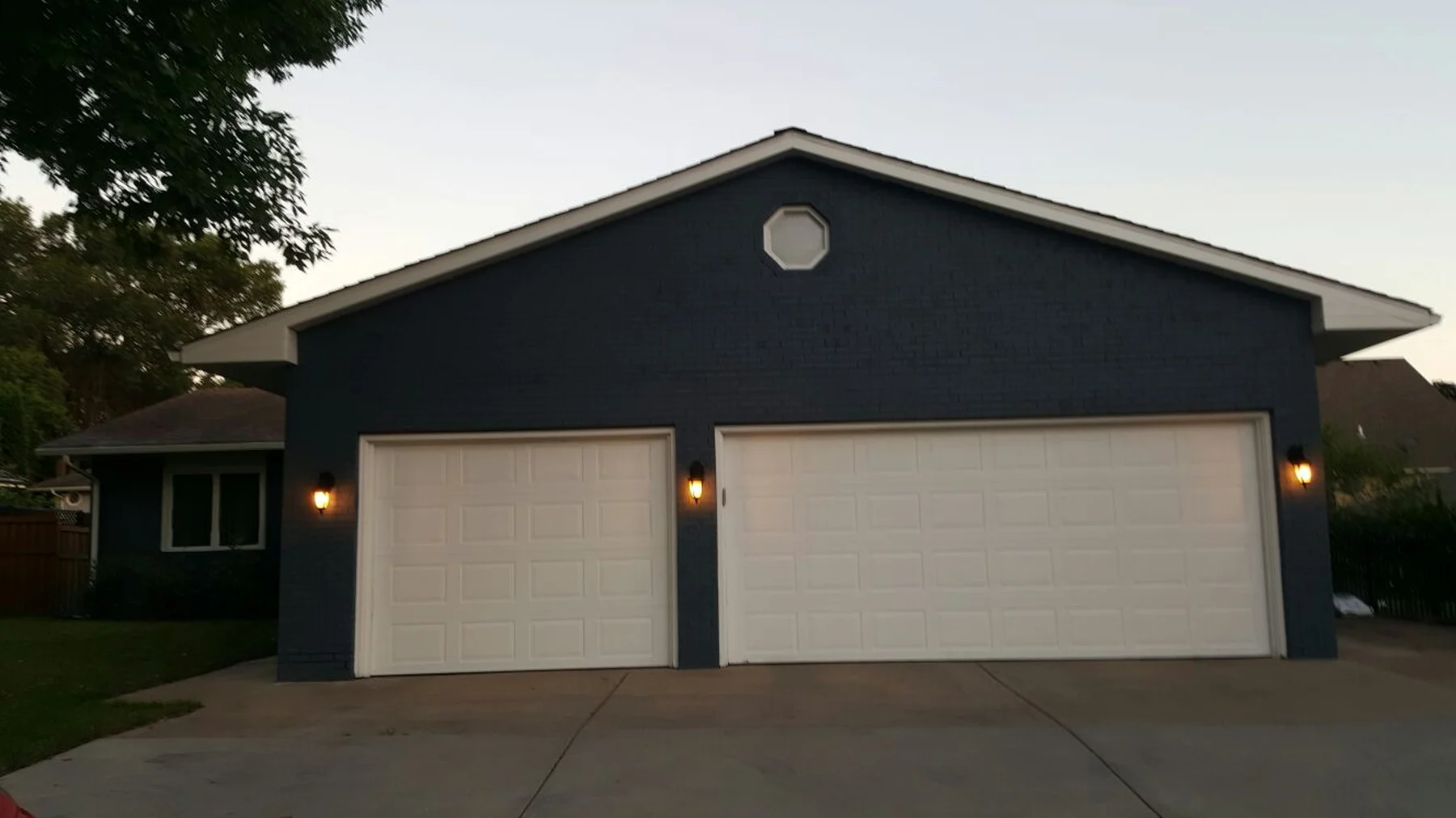 Finished navy-painted brick house and garage