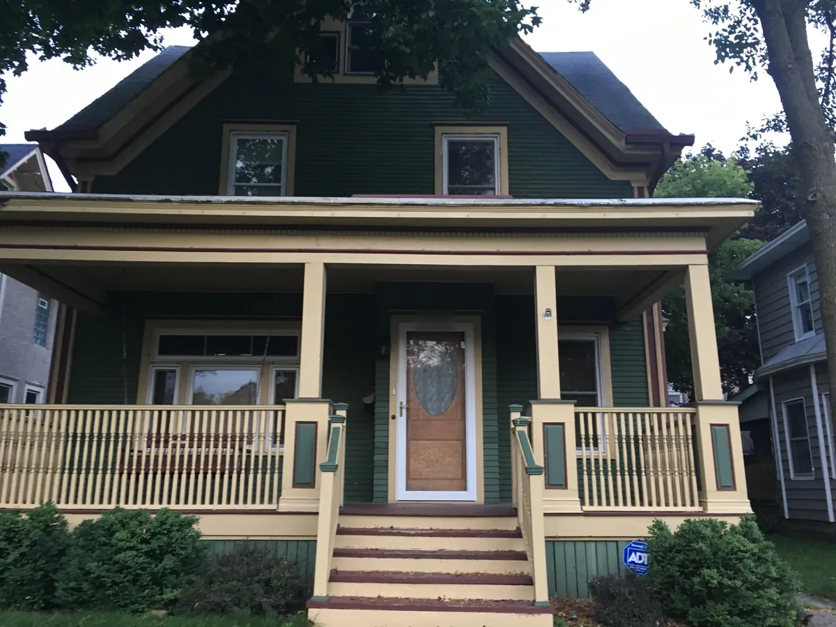 Front before: Exterior repaint (navy with white porch) · Minneapolis.