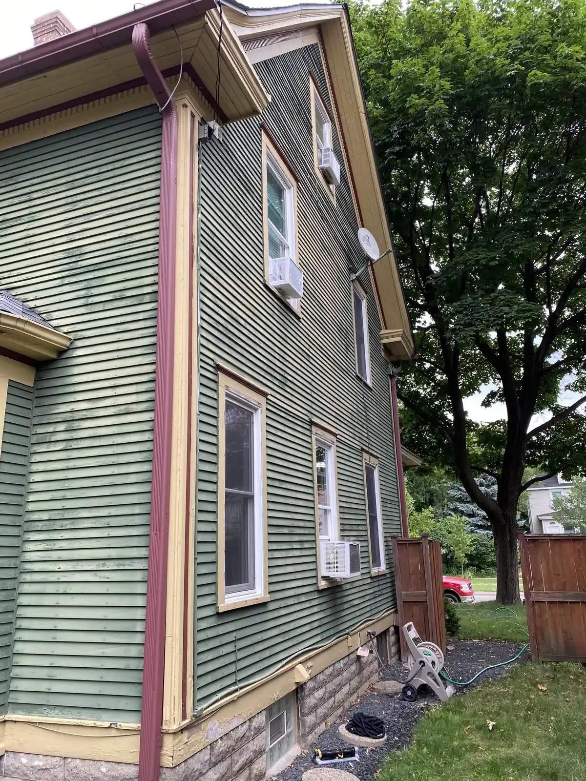Side before: Exterior repaint (navy with white porch) · Minneapolis.