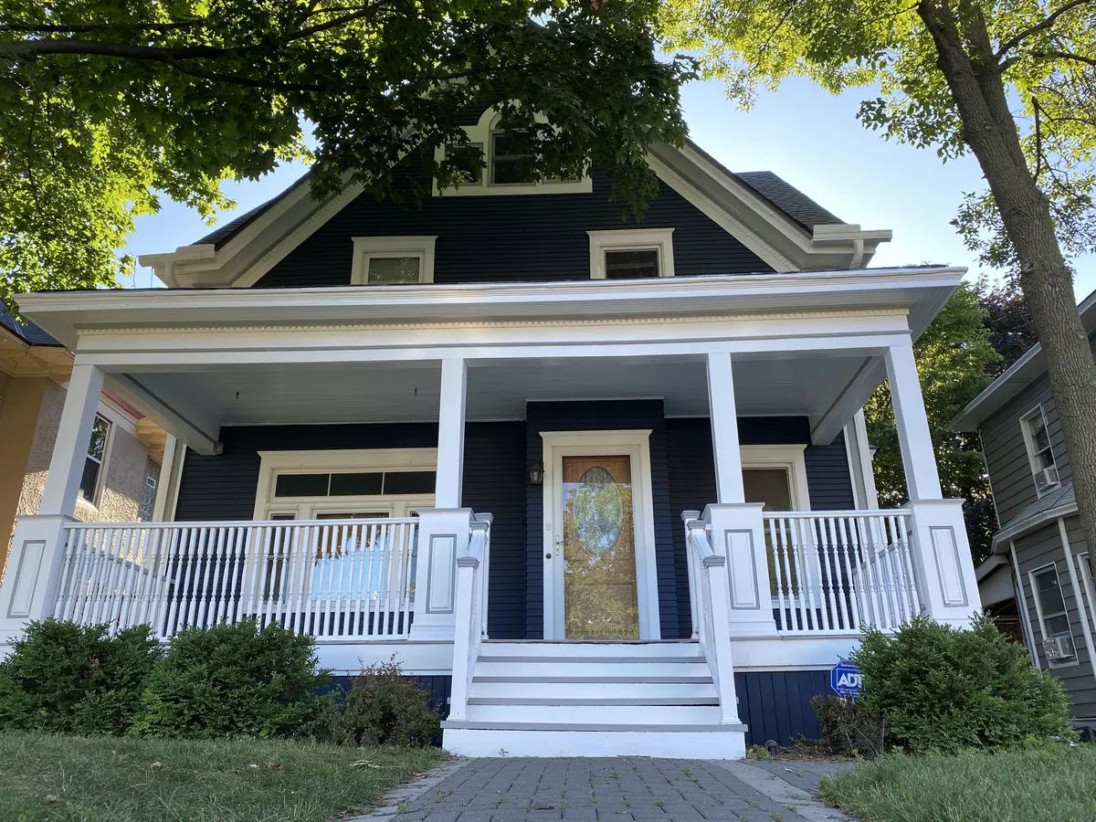 Front after: Exterior repaint (navy with white porch) · Minneapolis.