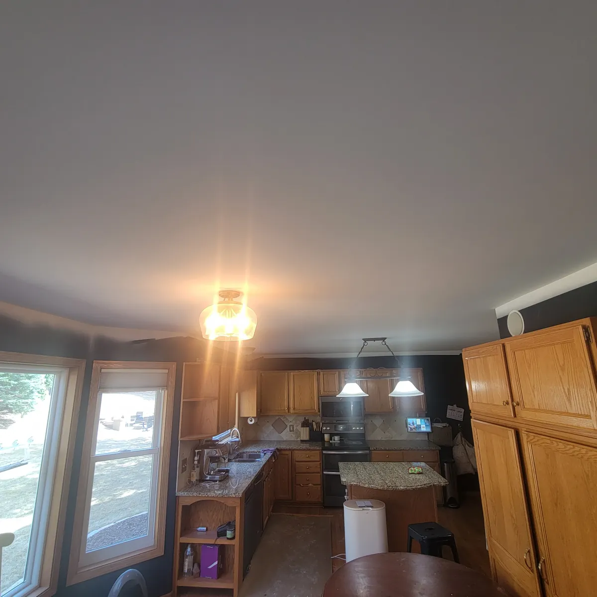 Finished smooth ceiling above kitchen: Popcorn texture removal · Eden Prairie.