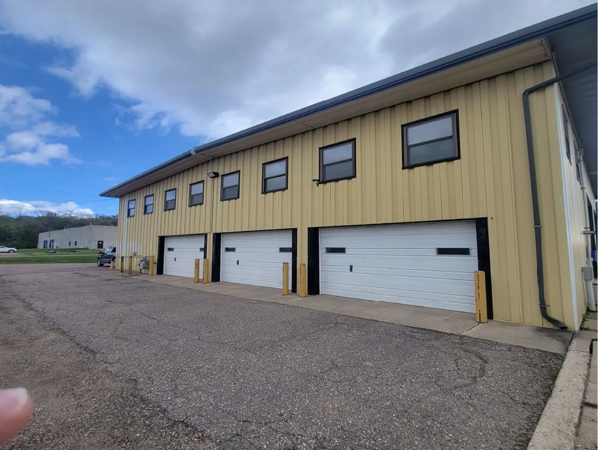 Before: whole maintenance hangar front exterior · Le Sueur