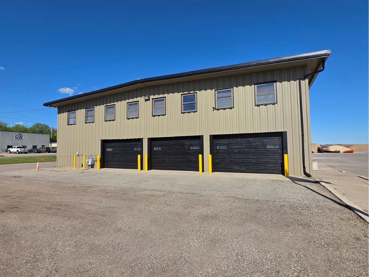 After: whole maintenance hangar front exterior · Le Sueur