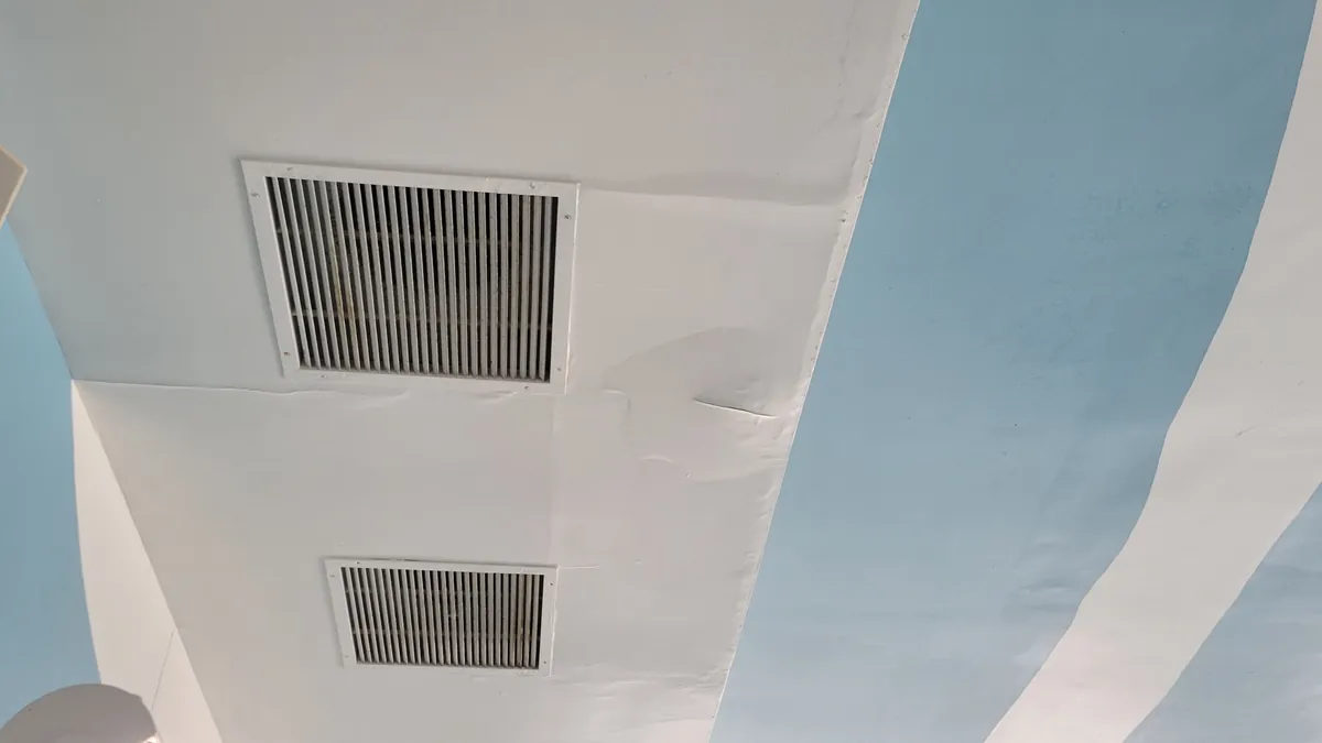 Before: peeling ceiling paint around the vents · Woodbury